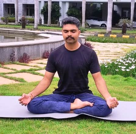 Raghav Rajauria meditating in a serene, peaceful green environment, embracing mindfulness and holistic healing.